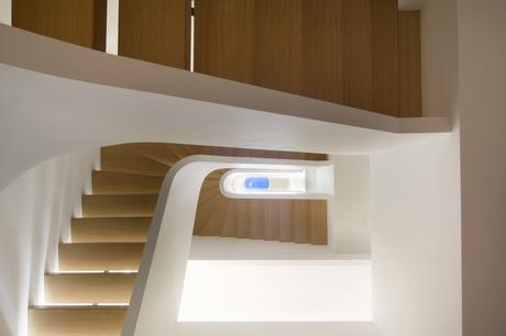 A view from the bottom of the staircase includes a skylight at the top.