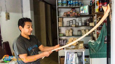 Pulling the traditional local taffy in the doorway of a shop in downtown Banos.