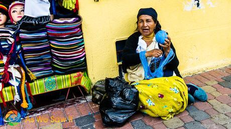 Ecuadorian woman winds blue yarn to make hats.