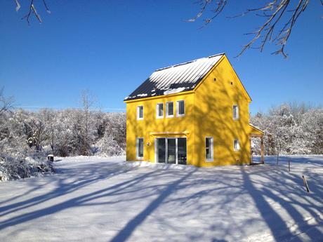 Yellow Passive house that runs on solar power