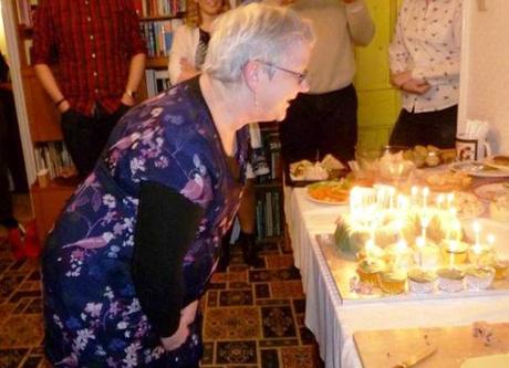 happy 60th birthday mom blowing out candles on cake