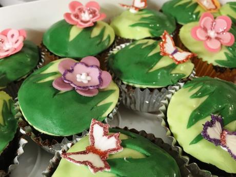 garden themed cupcakes flowers and butterflies on green grass fondant topping
