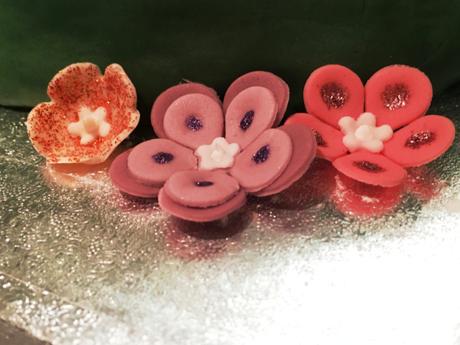 fondant icing edible flowers with glitter edging pink orange purple