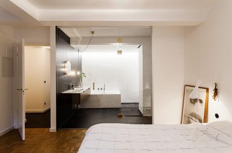 Hästens bed and AJ sconce by Arne Jacobsen for Louis Poulsen.