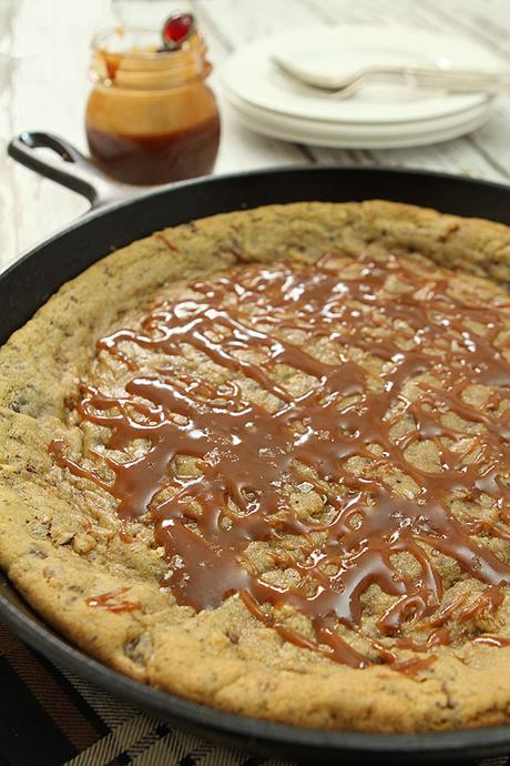 Salted Chocolate Chip Skillet Cookie with Pecans and Bourbon Caramel Sauce
