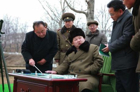 Kim Jong Un is briefed about the missile warhead simulation.  In attendance are WPK Senior Deputy Director Ri Pyong Chol (left) and WPK Munitions (Machine-Building)Industry Department deputy director and ballistic missile expert Kim Jong Sik (2nd right) (Photo: Rodong Sinmun).