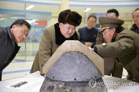 Kim Jong Un is briefed during a reentry simulation for a ballistic rocket.  Seen in attendance are WPK Munitions Industry (Machine-Building Industry) Deputy Director Kim Jong Sik (left) and KPA Strategic Force Commanding Officer, General Kim Rak Gyom (right) (Photo: KCNA-Yonhap).