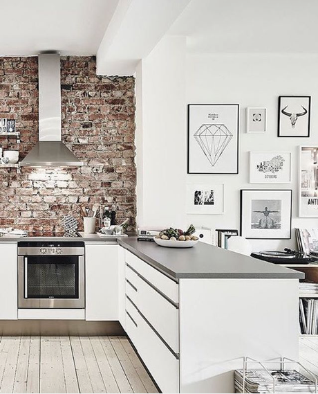 Kitchen with a brick wall and graphic art