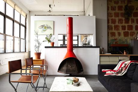 BoConcept sofa, restored steel chairs, and vintage 1960s fireplace in Brooklyn loft.