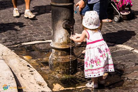 Little girl washing her hands outside the Pantheon