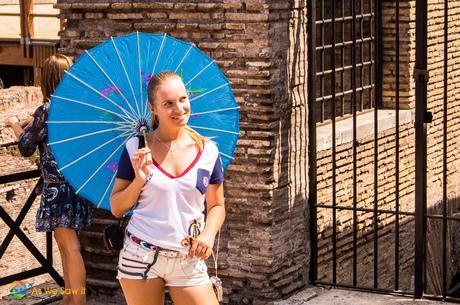 Woman poses with a paper umbrella; that must have been a really large drink!