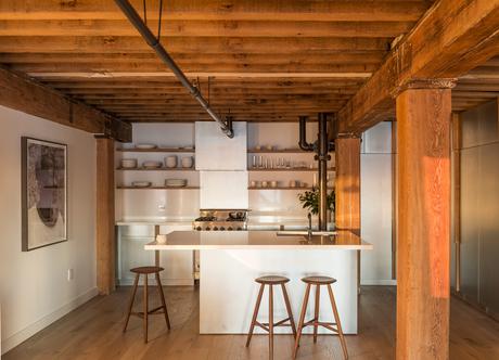 Counter stools from Sawkille, fir beams, and white oak floors in Manhattan apartment