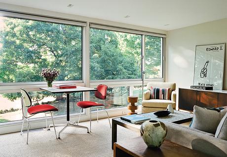 Modern guesthouse renovation in New York living room with Eames base table and plywood dining chairs by the window