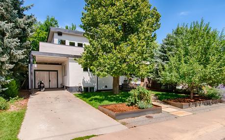 Boulder home clad in white-washed pine and stucco.