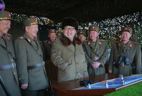 Kim Jong Un and members of the high command observe a large scale artillery drill (Photo: Rodong Sinmun).