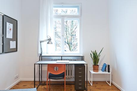 Desk that doubles as radiator cover in small space.