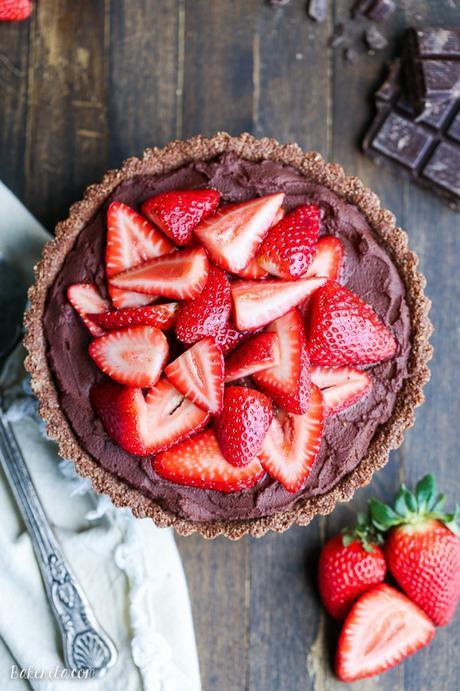 This Strawberry Chocolate Tart has whipped chocolate ganache made with coconut cream in a gluten-free chocolate crust, topped with fresh strawberries. Slice into this easy and delicious vegan, gluten-free, and Paleo dessert.