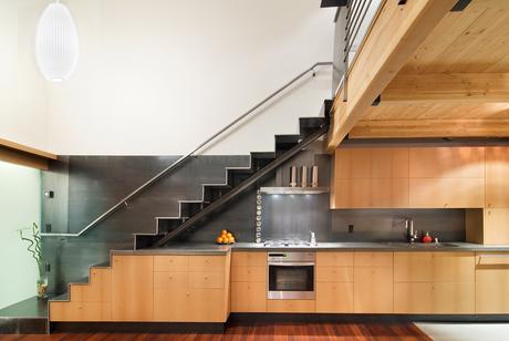A staircase hovers above architect Jack Hawkins' kitchen