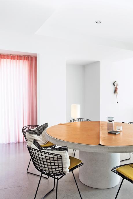 Modern dining room area with steel chairs by Harry Bertoia for Knoll
