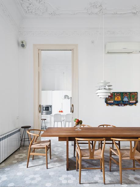 modern kithen with gray tile floor and wood dining table and chairs