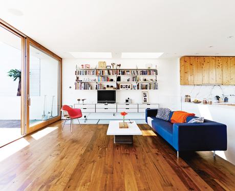 Modern living room with wooden floors and natural lighting