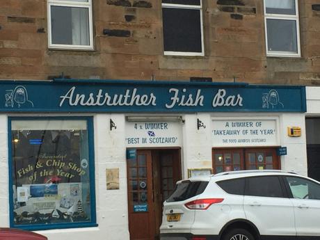 Eat haddock and chips from Anstruther fish bar whilst overlooking fishing boats