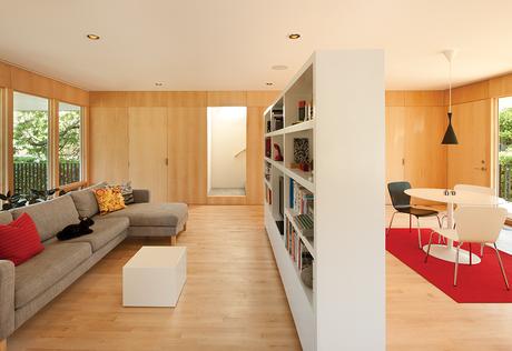 Affordable Portland home with custom bookshelf room divider between living and dining