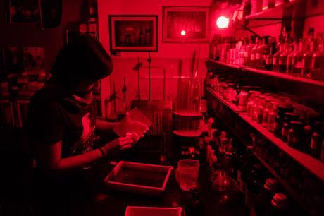 Charlene wipes off excess silver nitrate from the backside of the glass.