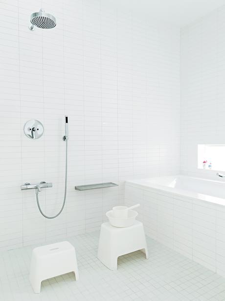 All-white master bathroom with Japanese-inspired communal shower
