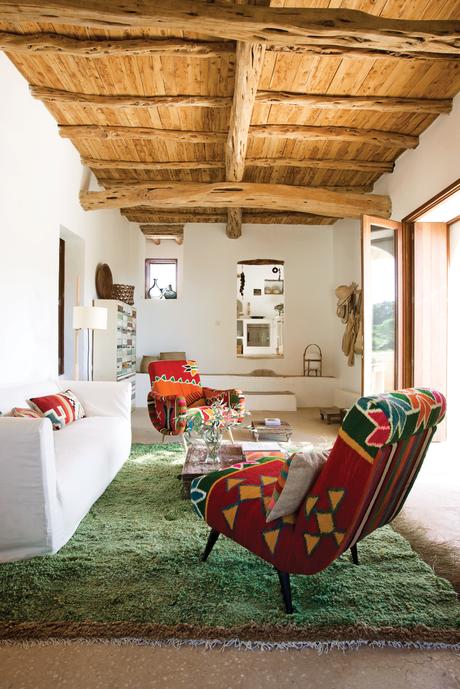 Modern colorful living room with Philippe Xerri chairs and Tunisian rug