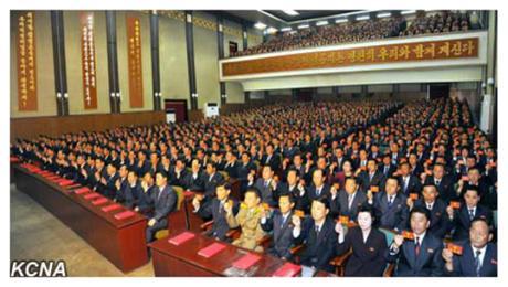 Party representatives hold up their party membership credentials during the North Hamgyo'ng provincial party conference (Photo: KCNA).
