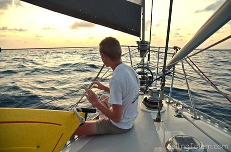 Dolphins play in the bow wake at sunset: Niall's getting close to hear them squeak