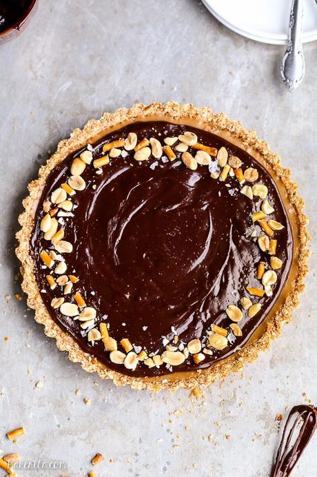 This Chocolate Peanut Butter Tart has a crunchy pretzel crust and smooth peanut butter caramel filling, all topped with luscious chocolate ganache. This recipe is gluten-free and vegan.