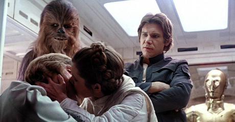 Leia kisses Luke, while Han & Chewie look on