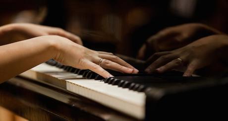 Hands of a woman playing the piano