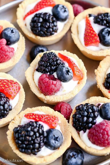 These Mini Berry Tarts have a shortbread crust with coconut cream filling and fresh berries! These sweet dessert bites are Paleo, gluten-free, and vegan.