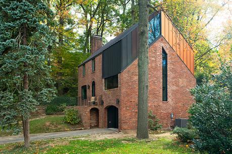 A renovated brick house with metal standing-seam roof in Arlington, Virginia