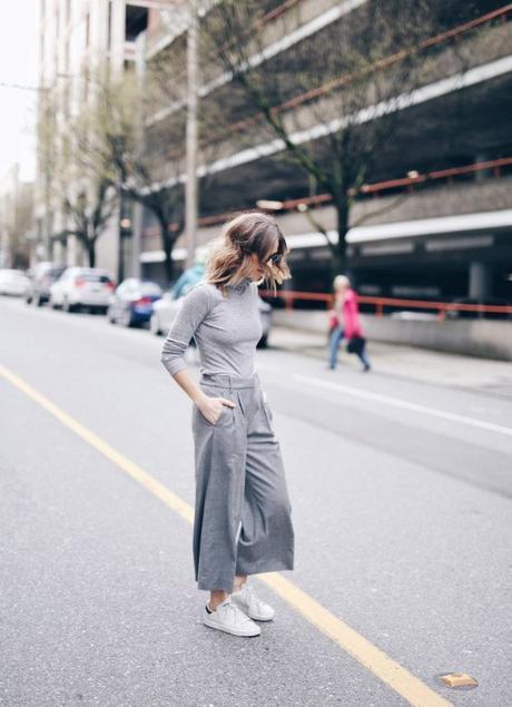 Combine the grey on grey and culottes trends to steal Jill Lansky’s awesome and individual style. Consisting of a grey turtleneck, grey culottes, and simple white sneakers, this look is perfect for work and leisure! Brands not specified. 