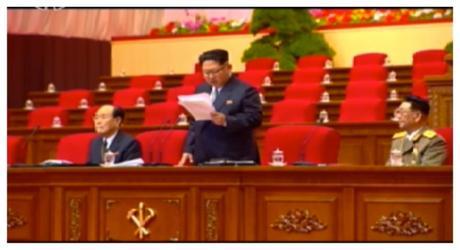 Kim Jong Un delivers the opening speech of the 7th Party Congress.  With him are the two current members of the WPK Political Bureau Presidium (Standing Committee): Kim Yong Nam (left) and Vice Marshal Hwang Pyong So (right) (Photo: Korean Central TV).