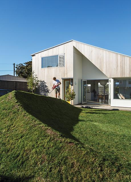 New Zealand house with angular cedar facade with cutaway