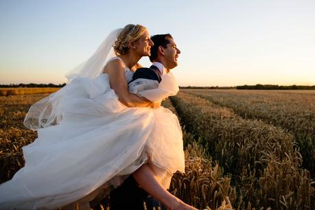 Barmbyfield Barn wedding couple inf ield at sunset