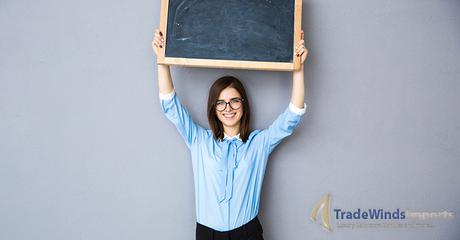 Happy woman standing with billboard over gray background. Wearing in blue shirt and glasses. Looking at camera