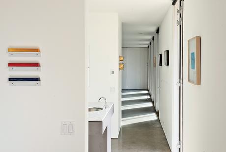 Hallway with series of glass doors that let light in