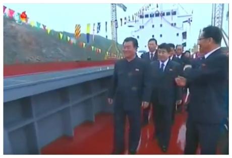 Cargo Ship Launched Minister of Land and Marine Transport Kang Jong Gwan briefs WPK Vice Chairman O Su Yong on the Jaryok (Photo: Korean Central TV).