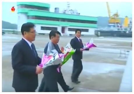 Cargo Ship Launched WPK Vice Chairman and Executive Policy Council Member O Su Yong along other senior DPRK officials delivers a floral bouquet to icons of Kim Il-so'ng and Kim Cho'ng-il at the Ryongnam Dockyards (Photo: Korean Central TV).