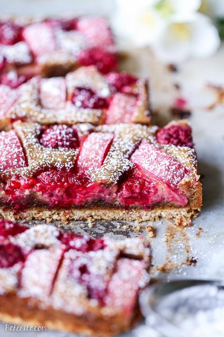 These Raspberry Rhubarb Almond Bars have an crisp almond-flour crust topped with soft almond frangipane, fresh raspberries, and tart rhubarb. This recipe is Paleo, gluten free + refined sugar free.