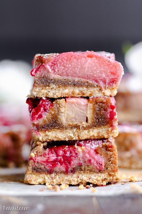 These Raspberry Rhubarb Almond Bars have an crisp almond-flour crust topped with soft almond frangipane, fresh raspberries, and tart rhubarb. This recipe is Paleo, gluten free + refined sugar free.