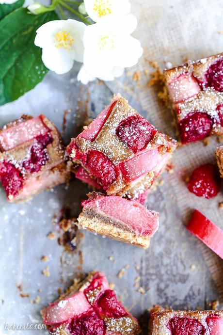 These Raspberry Rhubarb Almond Bars have an crisp almond-flour crust topped with soft almond frangipane, fresh raspberries, and tart rhubarb. This recipe is Paleo, gluten free + refined sugar free.