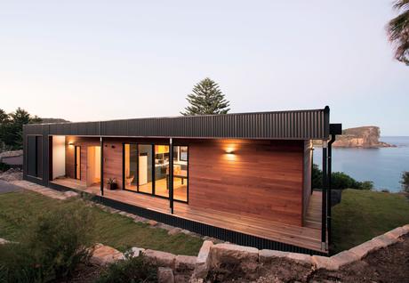 Modern beachside prefab home in Australia by Archiblox with colorbond ultra steel and queensland blue gum wood claddingon the facade