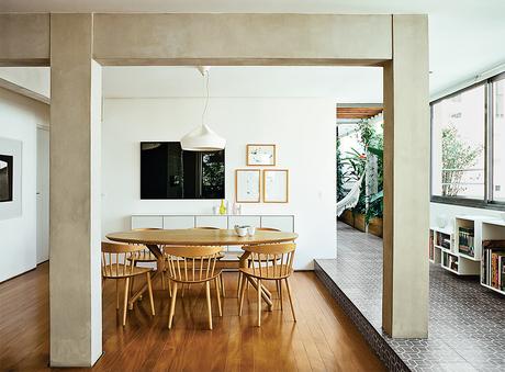 São Paulo apartment dining room with local wood floors and HAY chairs